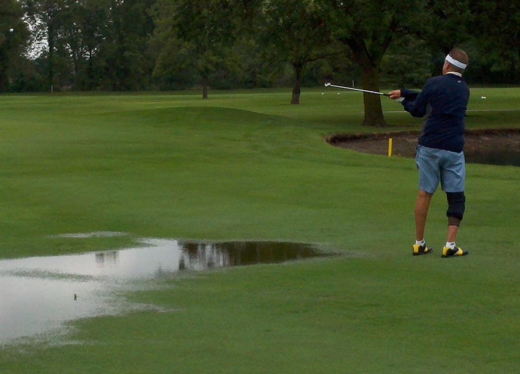  Glenn McKenzie chips up from the 14th fairway if you can call it that with the amount of water, and made a nice up and in.